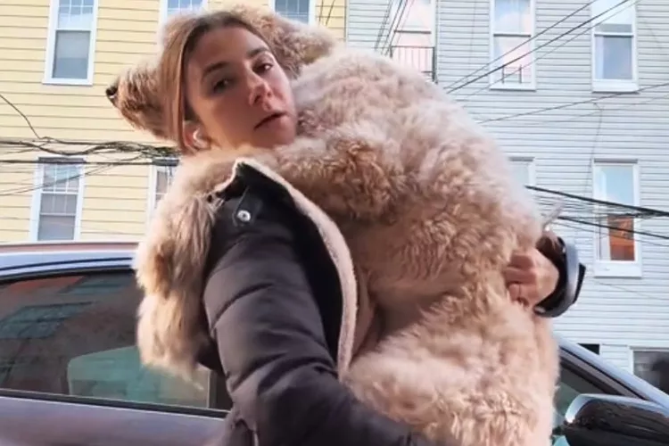 Woman carrying a large dog