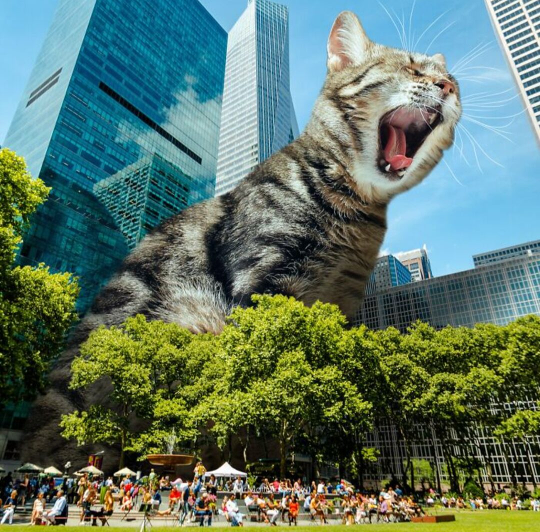 A digitally altered photograph depicts a cat towering over city skyscrapers and the people below. The cat's mouth is open wide.